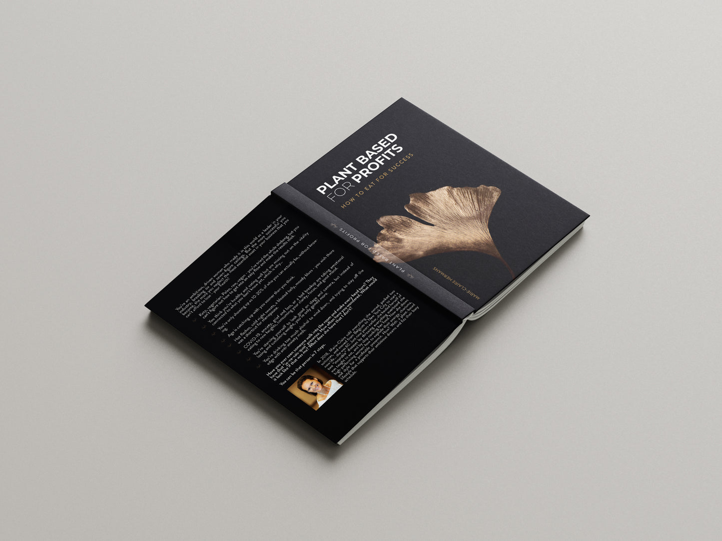 Plant Based for Profits hardcover book laying open and flat on a grey surface- How to Eat for Success by Marie-Claire Hermans